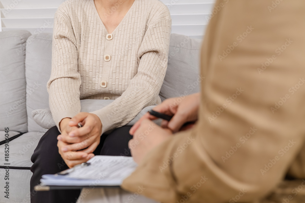 Fototapeta premium Therapy, counselor, psychologist, mental health consultation supports family trauma crisis, woman facing stress and emotion guided with empathy, private counseling discussion recovery building trust