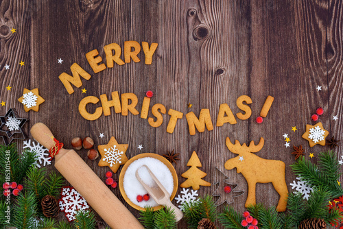 Holiday baking activity with festive decorations and tools for holiday preparation on a wooden background.