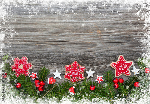 Christmas decorations and spruce branches on a wooden table. Festive background. Top view, copy space.