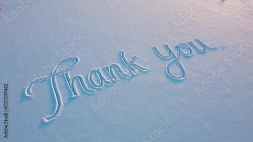 Sweeping motion thank you animation on snowy surface with elegant calligraphy style