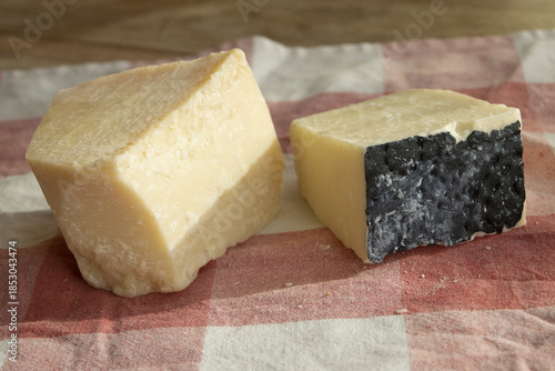 piece of parmesan and pecorino romano on rustic cloth with natural light
