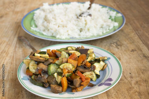 ratatouille mixed vegetables with basmati rice on wooden table