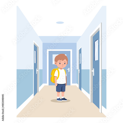 Young boy standing alone in school hallway with backpack  