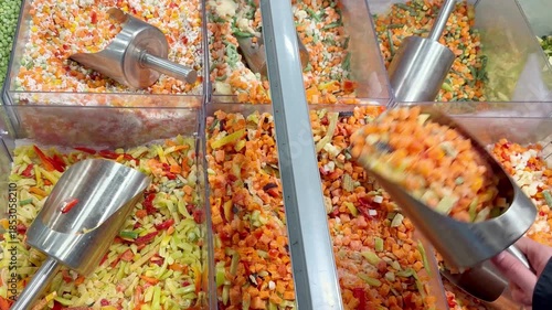 choosing frozen food from a supermarket freezer, reading product information