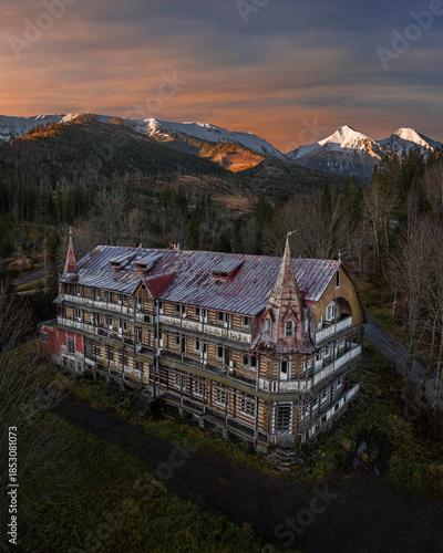 Zdiar, Slovakia - Aerial view of an abandoned wooden house in the High Tatras region of Slovakia at winter time with dramatic colorful sunrise sky