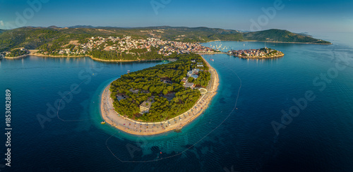 Primosten, Croatia - Aerial panoramic view of Primosten peninsula, beaches and old town on a sunny summer morning in Dalmatia, Croatia. Public beach and turquoise sea water at sunrise at the Adriatic