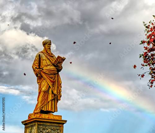 A fall Sean of Saint Paul in Rome with falling leaves and a rainbow touching him.