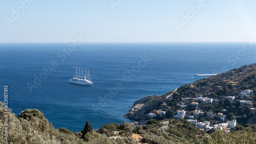 Sailing boat on blue sea near Ikaria island, Greece.Wide seascape with a sailing boat cruising on deep blue Mediterranean waters near Ikaria island, Greece. Minimal and peaceful travel background with