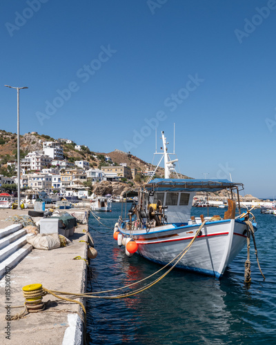 Traditional fishing boat moored in harbor, Agios Kirykos, Ikaria, Greece
Traditional small fishing boat moored at the harbor of Agios Kirykos on Ikaria island, Greece, with clear blue wate