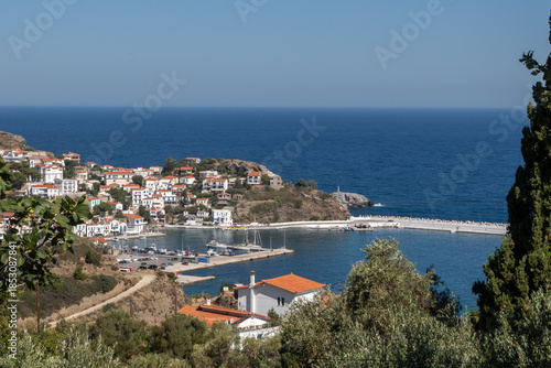 Agios Kirykos harbor and coastline, Ikaria island, Greece.Elevated view of Agios Kirykos harbor and coastline on Ikaria island, Greece, showing the village, marina and deep blue Aegean Sea. Travel and