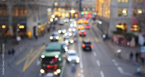Blurred city street at night with traffic lights creating a bokeh effect and moody atmosphere. Wide angle, real time video