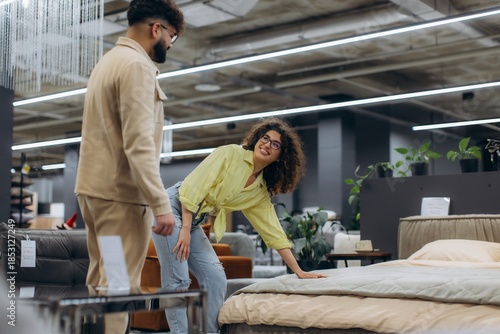 Couple shopping for mattress in furniture store