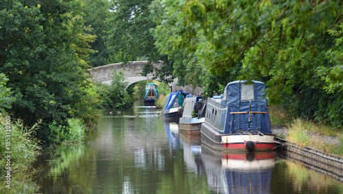 The Llangollen canal at Wrenbury close to Whitchurch with narrow boats moored and a bridge