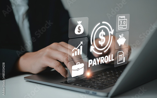 Photos Businessman working on laptop with payroll management system icons image