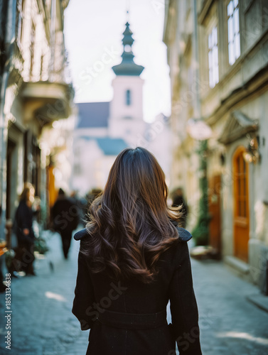Woman with beautiful hair exploring a historic European city street