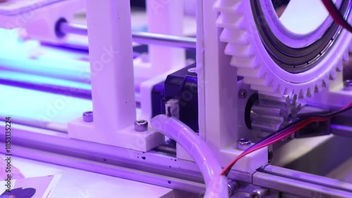 3d printed object with circular gear teeth being driven by a stepper motor. Mechanism of a motor and 3d printed part