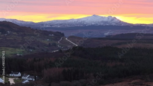 Aerial sunrise of the Glenties road with Carnaween, Chloghmeen and Binbane of the Bluestack Mountains seen from Portnoo in County Donegal, Ireland
