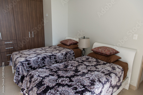 Bright guest bedroom with two twin beds and lake view window