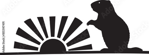 Silhouette of a groundhog looking at a rising sun with rays