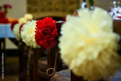 Red and white paper pom poms hanging as party decorations