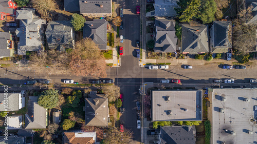 Aerial view of houses, buildings, streets, and cars create a geometric tapestry of urban life along Southeast 23rd Avenue, Portland, Oregon, United States.