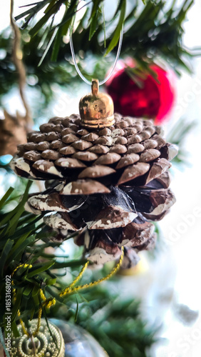 Close-up of Festive Pinecone and Glitter Star Ornaments on a Christmas Tree
