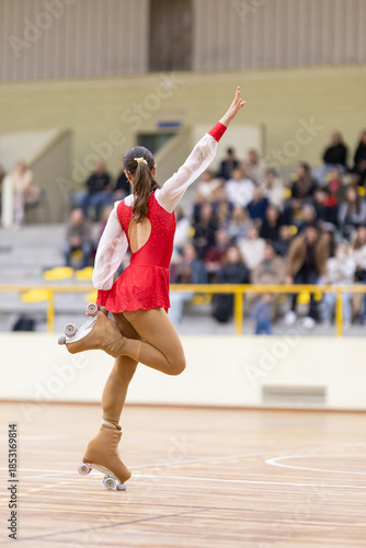 Female roller skater balancing on one leg performing artistic routine