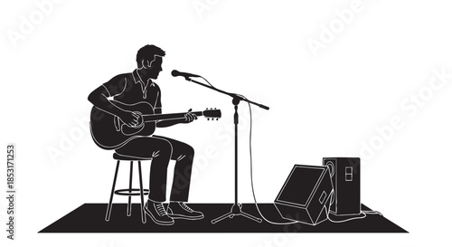 Silhouette of a male musician playing an acoustic guitar and singing into a microphone