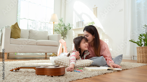 Mom and Daughter Enjoy Reading and Playing in Their Cozy Home During the Afternoon