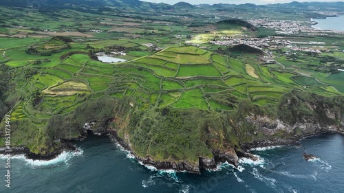 Patchwork farmland fields above rocky Atlantic shore on Sao Miguel Island, Azores. Aerial view
