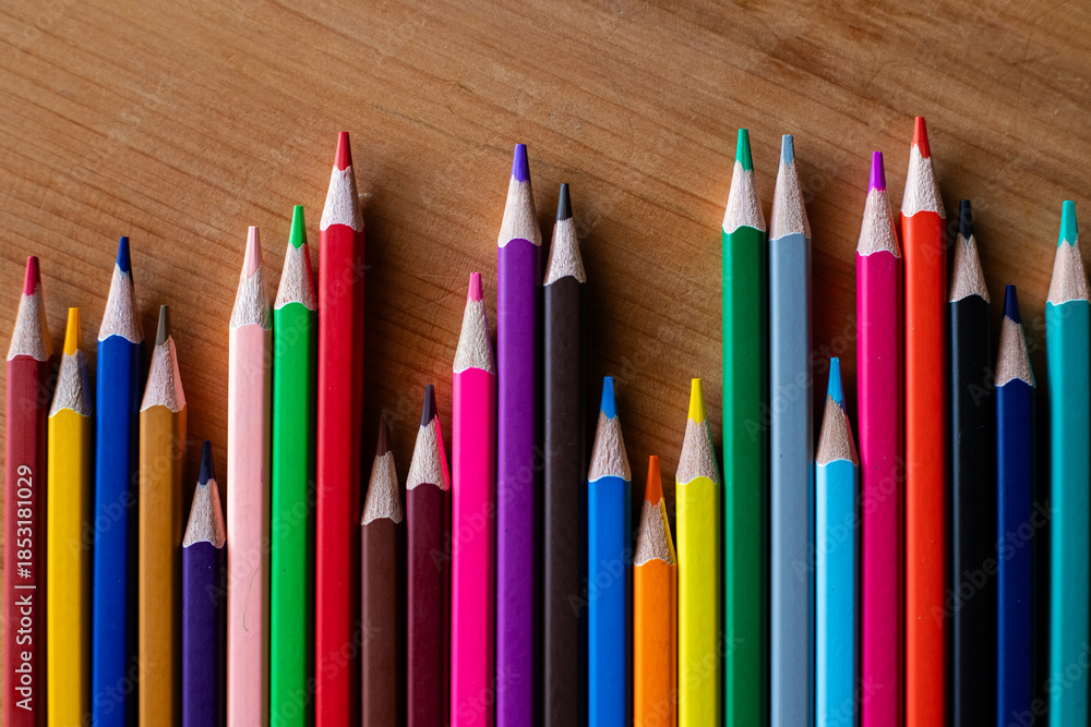 Fototapeta premium Colored pencils arranged like a bar graph (horizontal view).