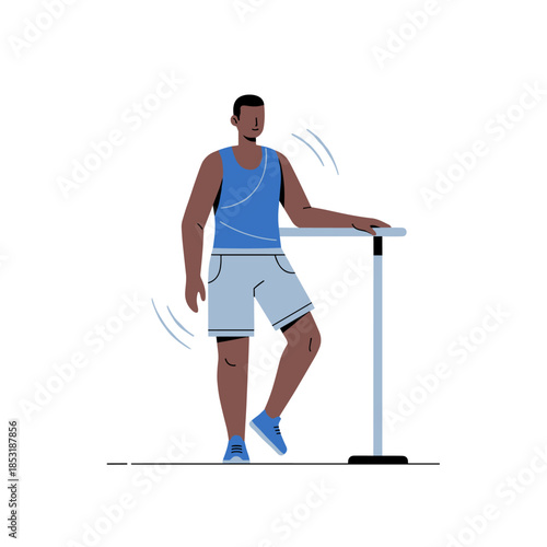 African male adult exercising at ballet barre in sportswear