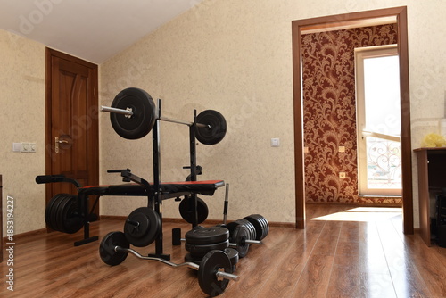 Home gym interior with weight bench and dumbbells, empty workout room at house, fitness equipment indoors, simple domestic training space and healthy lifestyle concept