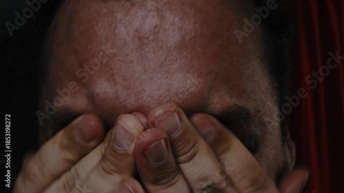 A grown man screams and cries in despair.