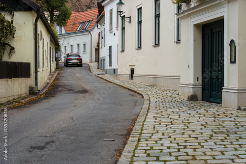 Car driving on narrow historic street in Austrian village