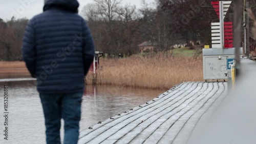 Stockholm, Sweden A man walks on a icy path in the winter countryside.