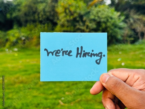 We are hiring trendy card post holding by hand, Join our team recruiting message, Drop your CV sticky note message, Vacancy here image