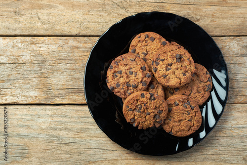 Freshly Baked Cookies on a Black Plate Placed on a Wooden Table