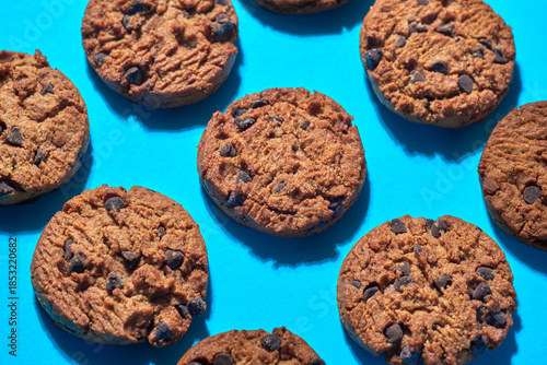 Cookies Arranged on a Blue Surface With Chocolate Chips Visible