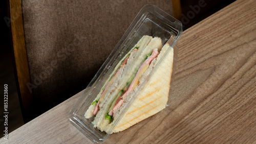 Club sandwich in plastic container
