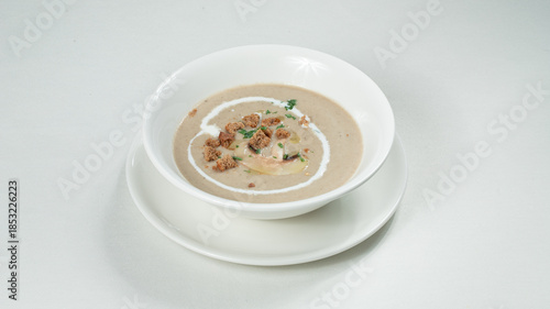 Bowl of mushrooms soup isolated