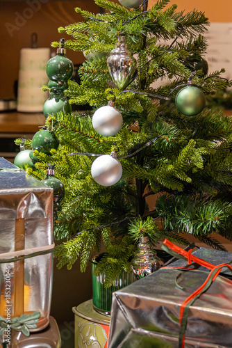 Decorated Christmas tree with presents inside modern room interior