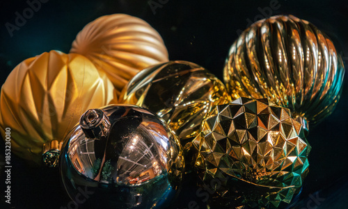 Shiny Christmas gold bulb ornaments on dark background