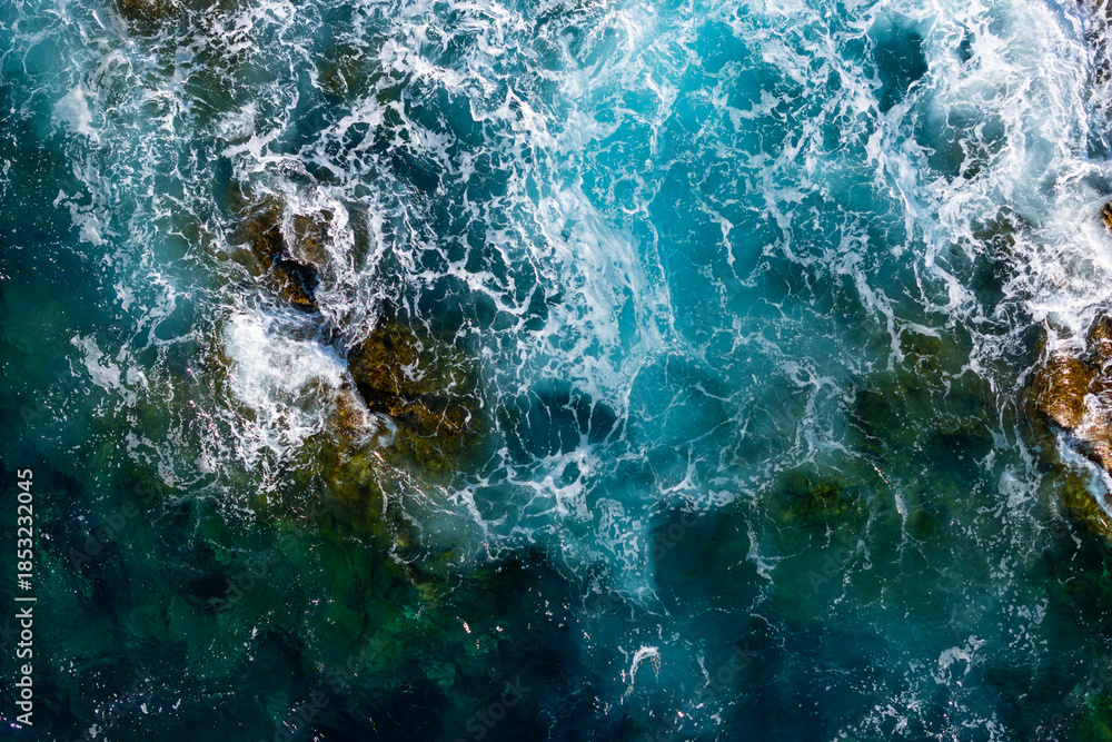 Fototapeta premium Sea coast with cliffs and foamy blue sea. Cinematic top-down drone footage, Clean and natural sea background