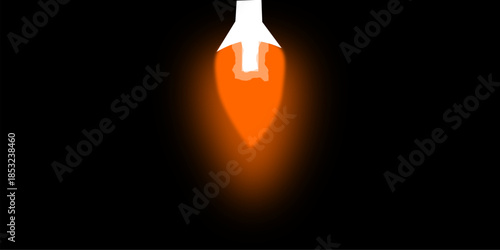 A white object emitting a vibrant orange flame or glow downwards against a dark black background, creating a striking contrast.