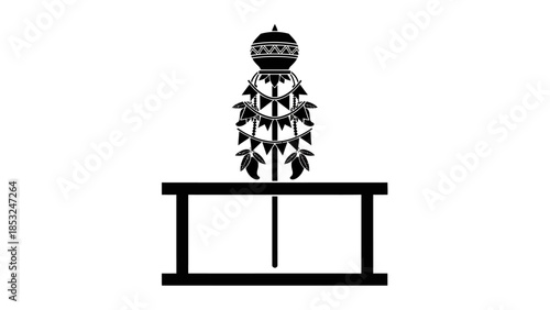 A decorative object sits on a table indoors in a gudi setting with cultural elements.