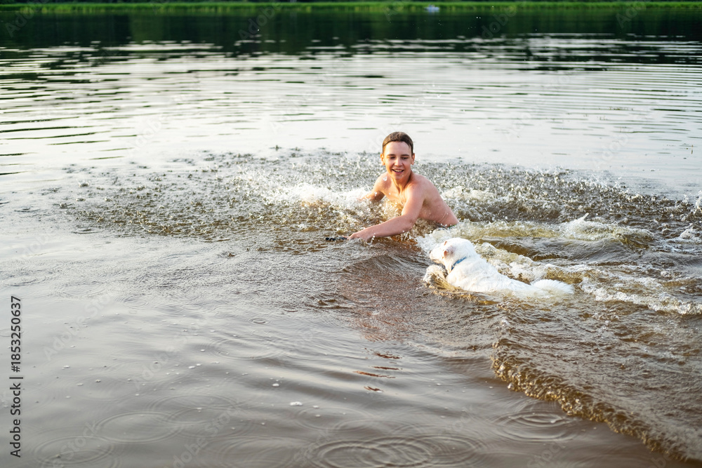 Fototapeta premium Man and Dog Splash in Water During Fetch Game
