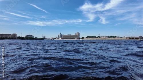 Beautiful view of the Neva River and the cityscape of St. Petersburg on a sunny summer day.