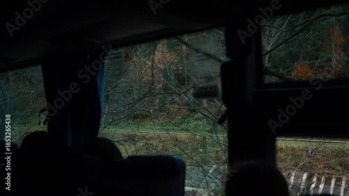 A beautiful view of nature from a train window during a journey. A railway in the mountains.