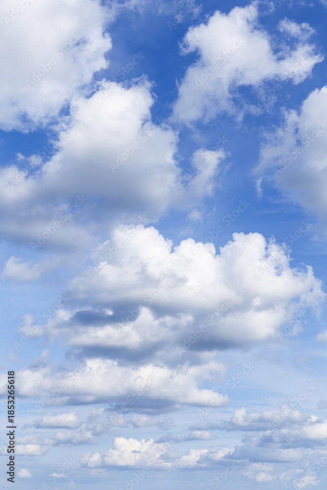 Fototapeta premium Beautiful soft gentle blue sky with white fluffy clouds background texture